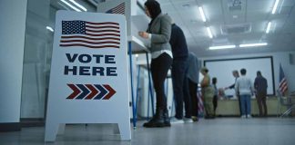 People voting in a booth.