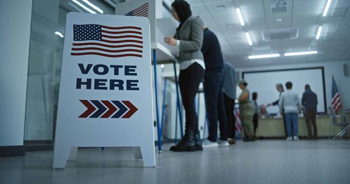 People voting in a booth.