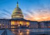 U.S. Capitol building illuminated at sunset.