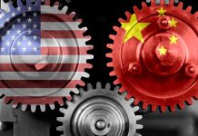 Interlocking gears with USA and China flags.