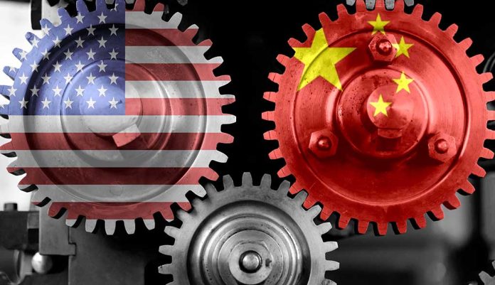 Interlocking gears with USA and China flags.