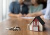 image of realtor and couple getting keys to a house