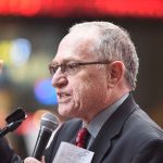 Lawyer Alan Dershowitz at a microphone