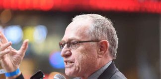 Lawyer Alan Dershowitz at a microphone