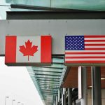 Canada and U.S. flags at an airport.