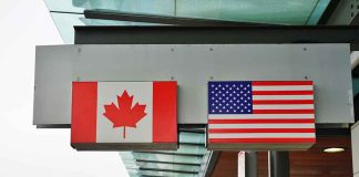 Canada and U.S. flags at an airport.