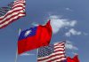 American and Taiwanese flags waving in the sky.