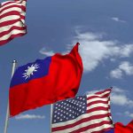 American and Taiwanese flags waving in the sky.