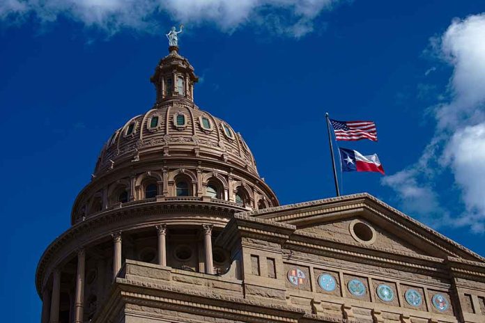 Building dome with US and Texas flags, blue sky.