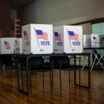 Voting booths set up in a room.