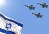 Israeli flag with three fighter jets flying overhead.