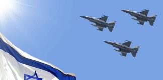 Israeli flag with three fighter jets flying overhead.