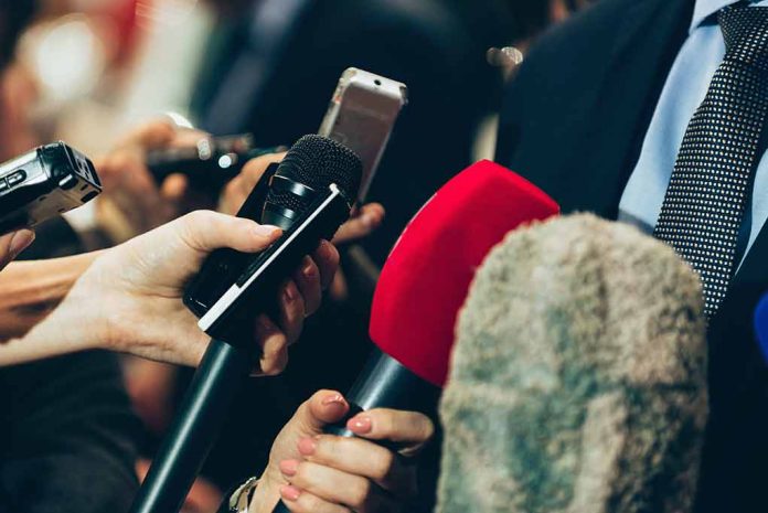 Close-up of various microphones held towards a person.