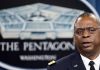 Man speaking in front of Pentagon sign.