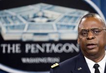 Man speaking in front of Pentagon sign.