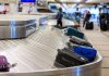 Luggage on airport baggage claim conveyor belt.