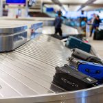 Luggage on airport baggage claim conveyor belt.