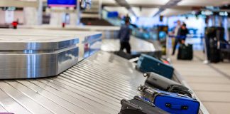 Luggage on airport baggage claim conveyor belt.