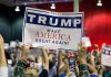 Crowd holding a "Trump Make America Great Again" sign.