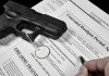 Handgun on concealed carry permit application forms.