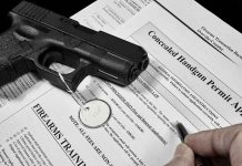 Handgun on concealed carry permit application forms.