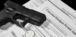 Handgun on concealed carry permit application forms.