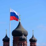 Russian flag next to church domes.