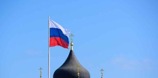 Russian flag next to church domes.