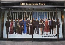 poster of the Saturday Night Live cast in a store window