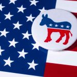 Democratic donkey button on American flag background.