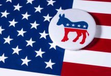 Democratic donkey button on American flag background.