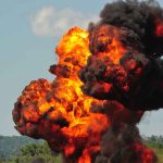 Large explosion with fireball and smoke cloud.