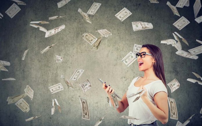 Woman holding phone surrounded by falling money