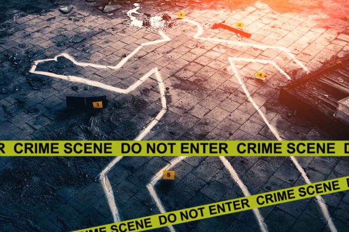 Chalk outline at a crime scene with evidence markers.