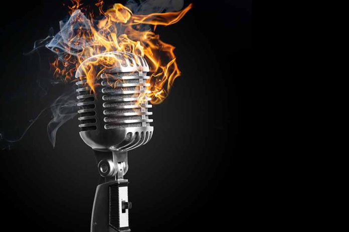 Vintage microphone engulfed in flames and smoke.