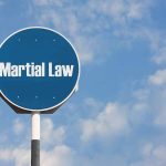 Martial Law sign against blue sky background