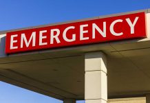 Red "EMERGENCY" sign on building facade.