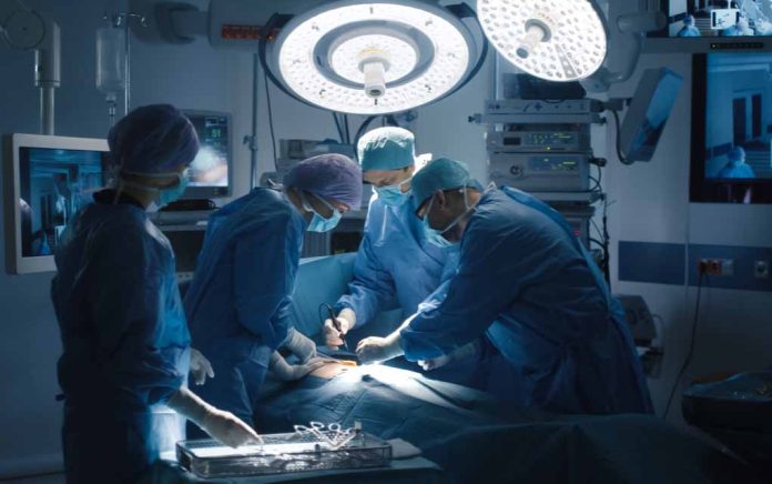 Surgeons performing a surgery in an operating room.