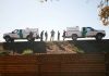 Border patrol agents near vehicles on embankment daytime