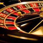 Close-up of roulette wheel with spinning ball.