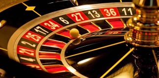 Close-up of roulette wheel with spinning ball.