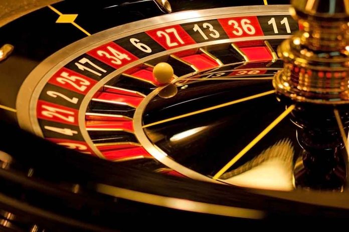 Close-up of roulette wheel with spinning ball.