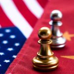 Chess pawns on USA and China flags.