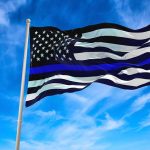 Black and white flag with blue stripe flying