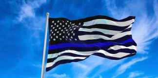 Black and white flag with blue stripe flying