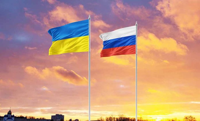 Ukrainian and Russian flags against vibrant sunset sky