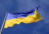 Ukrainian flag waving against a blue sky.