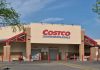 Costco Wholesale store exterior with entrance and exit signs.