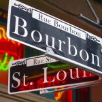 Bourbon and St Louis street signs with neon lights