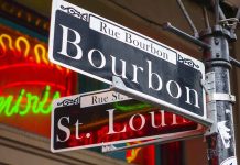 Bourbon and St Louis street signs with neon lights